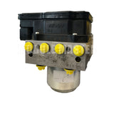Side View of Nissin ABS Module for Honda Civic and Accord with yellow plugs in the brake line port.
